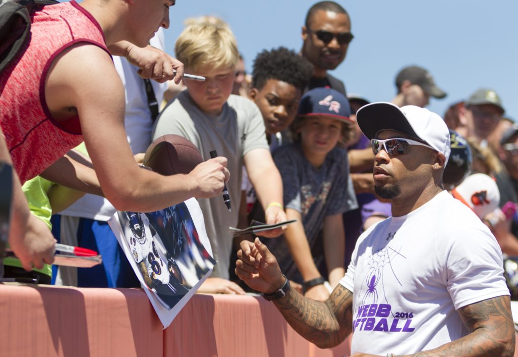 Steve Smith, Sr. of the Baltimore Ravens is seen signing autographs for fans at the seventh annual charity softball game sponsored by the Lardarius Webb Foundation. Photo by JERMAIN RANGASAMMY