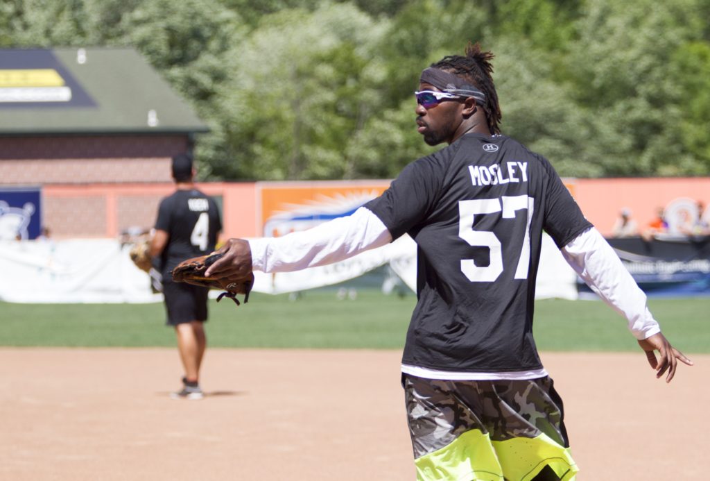 Ravens' C.J. Mosley is warming up in the outfield in preparation for the charity softball game at Ripken Stadium.