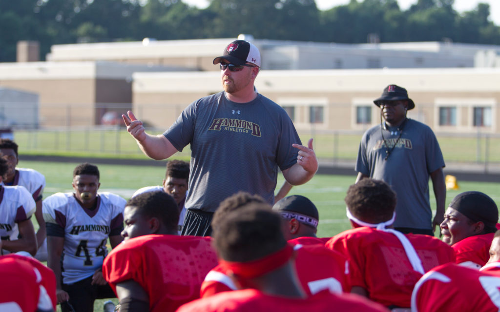 Hammond Golden Bears Varsity Coach Shawn Frederick goes over the rules with his team and the Baltimore Edmondson Westside High School football squad before the August 26 scrimmage at Hammond High School. EWHS turned two touchdown passes into a 12-0 victory. 