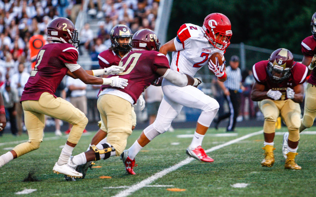  Hammond defender Francis Afoakwah zeroes in on Centennial ball carrier Michael Klein for a tackle in the first half of the 2016 season opening game at Golden Bear Stadium. The Centennial Eagles defeated Hammond 30-21 Friday night. Photo by YANAIR PHOTOGRAPHY