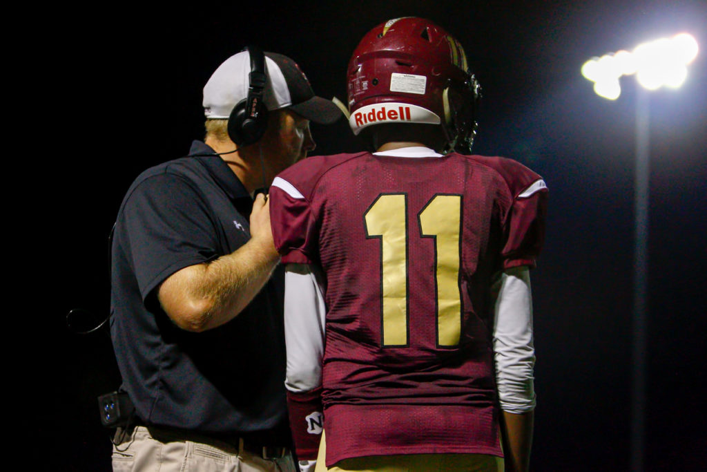 Hammond Golden Bear Head Coach Shawn Frederick calls a play while quarterback Elijah Lindsey listens during the second half of a 44-0 loss to the Glenelg Gladiators Friday at Hammond High School. Photo by YANAIR PHOTOGRAPHY.