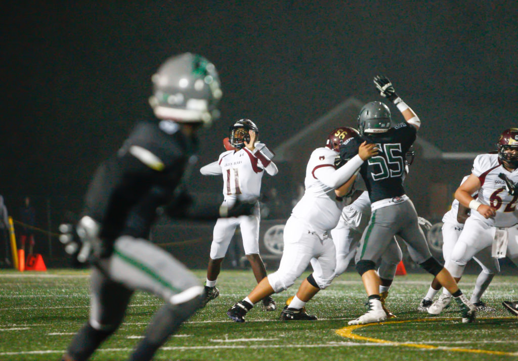 Hammond quarterback Elijah Lindsey drops back for a pass attempt in HHS’ opening possession during the first quarter against the Atholton Raiders at Atholton High School Friday night. Lindsey threw a third quarter touchdown pass to Paskel Cheeves in AHS’ 51-6 win over the Golden Bears. Photo by YANAIR PHOTOGRAPHY. 