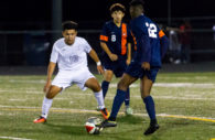 Hammond Golden Bear soccer forward Anthony Perez defends against Reservoir forward Kyree Akinkuowo while RHS midfielder Rudy Ventura watches during Reservoir’s 2-1 win Friday at Hammond High School. Perez scored the only goal for the Golden Bears. Photo by YANAIR PHOTOGRAPHY.