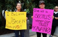 And has the following caption: WASHINGTON - Two Kavanaugh protesters, carrying "KavaNO" signs in support of Ford. (Albane Guichard/Capital News Service)