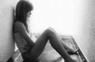 Depressed sad teenage girl sitting alone on the floor tiles