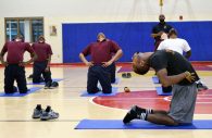 Larry Jackson leads boys at the Baltimore City Juvenile Justice Center in a yoga pose on Sept. 25, 2018. (Courtesy of Eric Solomon)