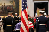 WASHINGTON - An American flag and member of the military honor guard at President George Herbert Walker Bush's coffin in the United States Capitol Rotunda. (Albane Guichard/Capital News Service)