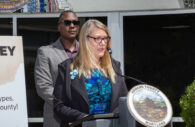 Coleen West, Executive Director at Howard County Arts Council seen giving remarks with Howard County Executive Calvin Ball directly behind her. (Photo:: Courtesy, Howard County Government)